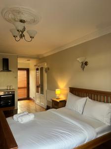 - une chambre avec un grand lit et des draps blancs dans l'établissement Charming Vintage studio near NEC, BHX & Resort World, à Birmingham