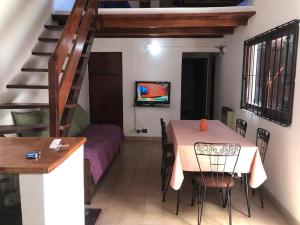 a dining room with a table and a couch at Refugio Atlántico in San Bernardo