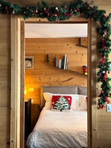 a bedroom with a bed with a christmas decoration at Maison Rododendro Elegant in Breuil-Cervinia