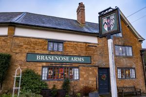 a brick building with a sign in front of it at The Brasenose Arms in Banbury