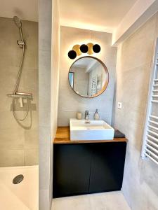 W łazience znajduje się umywalka i lustro. w obiekcie Laureto BnB w mieście Roquebrune-Cap-Martin