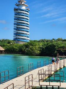 a person standing on a dock with a building in the background at Hotel San Vicente in Playa del Carmen