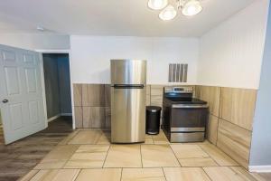 a kitchen with a stainless steel refrigerator in a room at Large 6BR, 6 Bath in the city of Niagara Falls in Niagara Falls