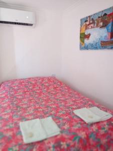 a bedroom with a bed with two plates on it at Los tordos posada in Puerto Madryn