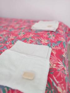 a piece of paper sitting on top of a bed at Los tordos posada in Puerto Madryn