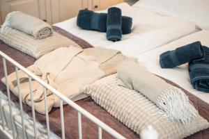 a group of blankets and pillows on a bed at VB36 Vendégház in Villány