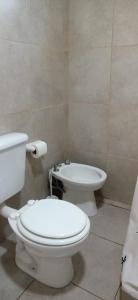 a bathroom with a toilet and a bidet at Los tordos posada in Puerto Madryn