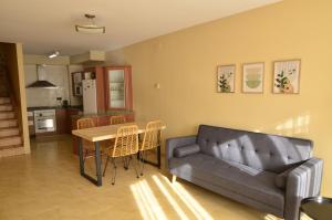 a living room with a couch and a table at La Caseta del Picatxo in Batea