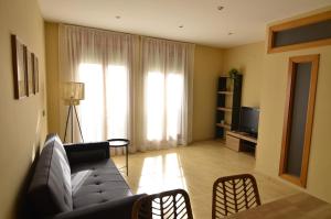 a living room with a couch and a television at La Caseta del Picatxo in Batea