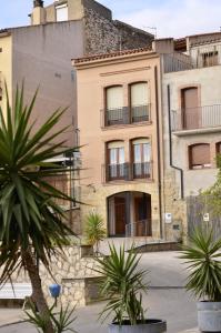 an old building with palm trees in front of it at La Caseta del Picatxo in Batea