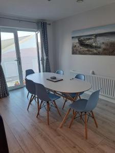 a dining room with a table and chairs at Royal Atlantic View Apartment in Portrush