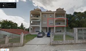 a large house with a car parked in front of it at Διαμέρισμα στη χλόη Καστοριάς in Kastoria