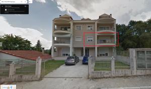 a large house with a car parked in front of it at Chloe Maxi Apt 110sqm in Kastoria