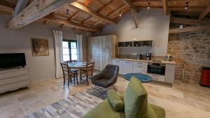 a kitchen and living room with a table and chairs at Domaine de Montboulard in Soyaux