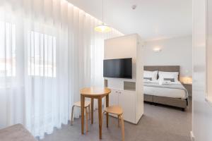 a bedroom with a bed and a table and chairs at Soho Porto in Porto