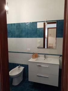 y baño con lavabo, aseo y espejo. en Splendido appartamento a Lampedusa, con terrazzo !, en Lampedusa