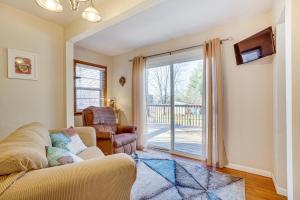 a living room with a couch and a sliding glass door at Chippewa Falls Vacation Rental 6 Mi to Eau Claire in Chippewa Falls