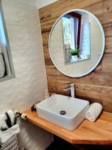 a bathroom with a white sink and a mirror at HAFCIK Apartamenty przyjazne dzieciom in Poronin