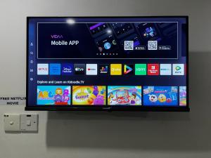 a flat screen tv hanging on a wall at One Avenue Hotel Balakong in Seri Kembangan +21 photos