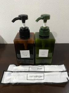 two bottles of soap sitting on top of a table at One Avenue Hotel Balakong in Seri Kembangan