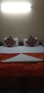 two beds with pillows on them in a room at Brookefield Service Apartment in Bangalore