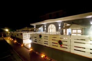 a white building with lights in front of it at night at City Pompei Accommodations in Pompei
