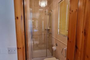 a bathroom with a glass shower with a toilet at Ramla Boutique Home in Marsaskala