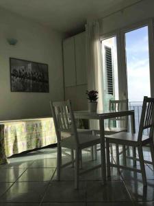 d'une salle à manger avec une table, des chaises et une fenêtre. dans l'établissement Il Fico “Villa Nunzia”, à Ischia