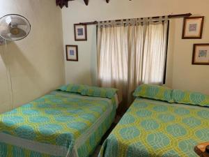 A bed or beds in a room at Villa Fe Esperanza - Vistas al Valle de Constanza