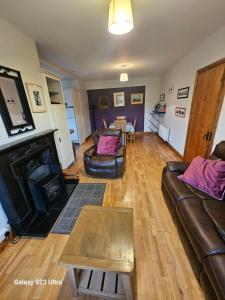 uma sala de estar com um sofá e uma mesa em Roadside Cottage The Burren Kilfenora County Clare em Kilfenora