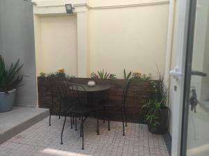 a table and chairs on a patio with plants at Oporto Lovely House in Porto