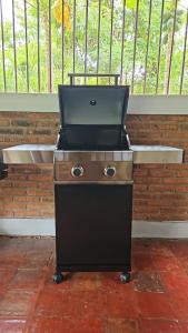 a bbq grill sitting on top of a red floor at Roemah Uli Cirebon in Cirebon