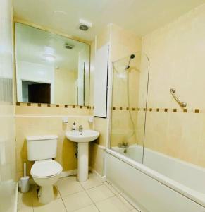 a bathroom with a toilet and a sink and a shower at Specious Parkview Apartment, 4 Mins Walk to Underground in Barkingside