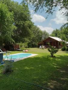 un patio con piscina y una casa en cabañas Khuska en Bialet Massé