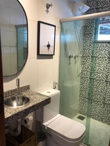 a bathroom with a shower and a toilet and a sink at Sinta-se em casa. in Barbacena