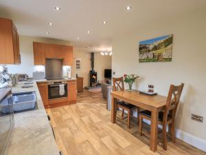 a kitchen with a table and a dining room at Orcaber Farm Retreat in Lancaster