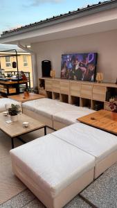 a room with several beds and a flat screen tv at Duplex de la Gare, Grande Terrasse, Jacuzzi in Corbeil-Essonnes