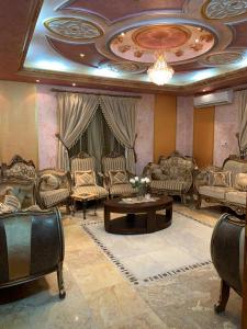 a living room with couches and a table at فيلا بالعلا in AlUla