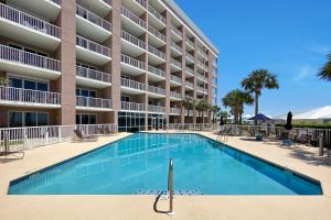 a swimming pool in front of a building at The Clubhouse - Fort Morgan in Gulf Shores