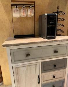 a microwave on top of a dresser with a toaster oven at فيلا بالعلا in AlUla
