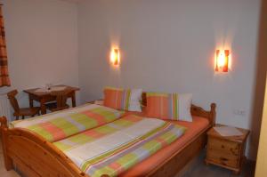 a bedroom with a bed with two lights on the wall at Gästezimmer Peterbauer in Dorfgastein