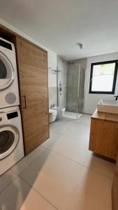 a bathroom with a washer and a washing machine in it at Chalet Bergfuchs in Anterselva di Mezzo +22 photos