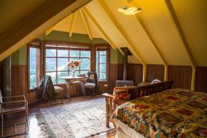 a bedroom with a bed and a table in a room at Barraco Lodge in Puelo +191 photos