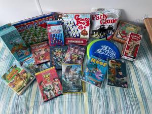 a pile of games and books on a bed at JSNHolidays@CraigTara in Ayr