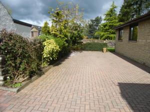 a brick driveway in a yard next to a building at Kirkside in Auchterarder