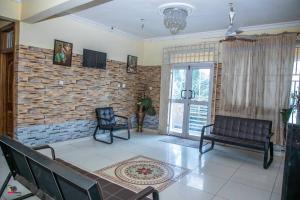 Jukambo Lodge : غرفة معيشة مع أريكة وجدار من الطوب
