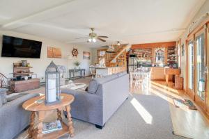 a living room with a couch and a table at Riverfront Kingston Cottage w/ Deck, 2 Mi to Beach in Kingston