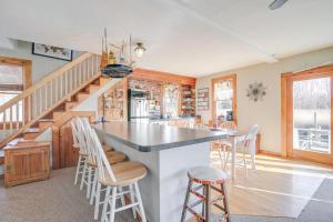 a kitchen with a large island with bar stools at Riverfront Kingston Cottage w/ Deck, 2 Mi to Beach in Kingston