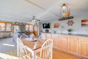 a dining room and kitchen with a table and chairs at Riverfront Kingston Cottage w/ Deck, 2 Mi to Beach in Kingston +18 photos