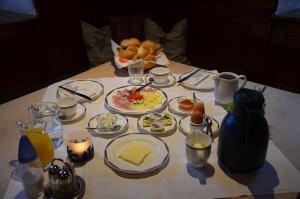 a table with a breakfast of eggs and food on it at Gästezimmer Peterbauer in Dorfgastein